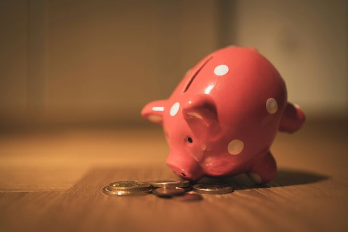 A red piggy bank with white polka dots hunts for spare change.