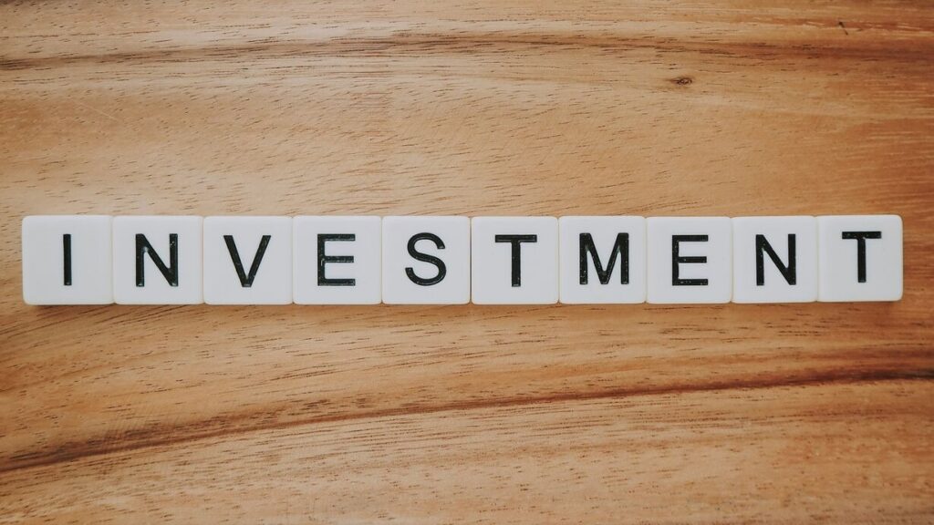 The word "investment" spelled using Scrabble letters.